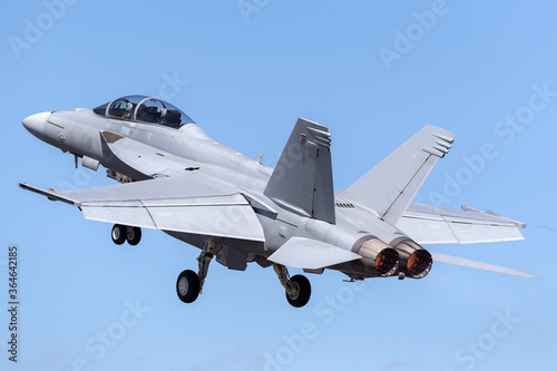 F/A-18F Super Hornet multirole fighter aircraft taking off into a blue sky. photo