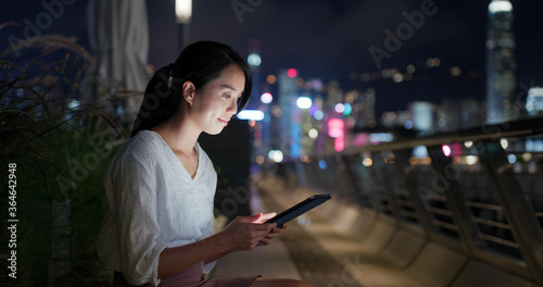 Woman use of tablet computer at night