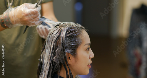 Woman dye her hair at beauty salon