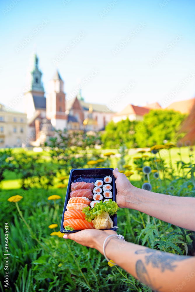 Sushi to go outdoors. Healthy eating out. In the city