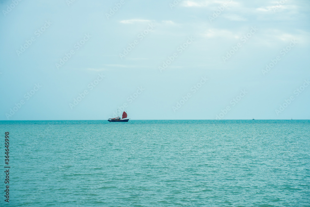 A large sailboat in the middle of the sea