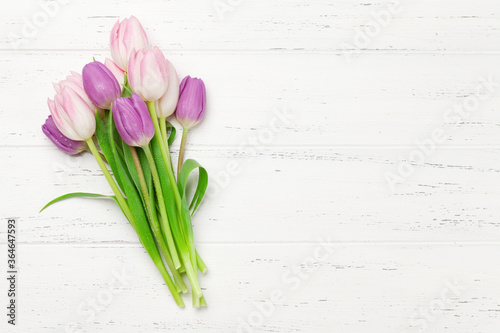 Pink tulips over wooden background