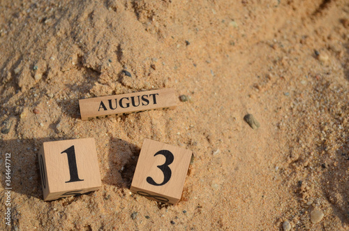 August 13, Number cube with Sand pile for a background.