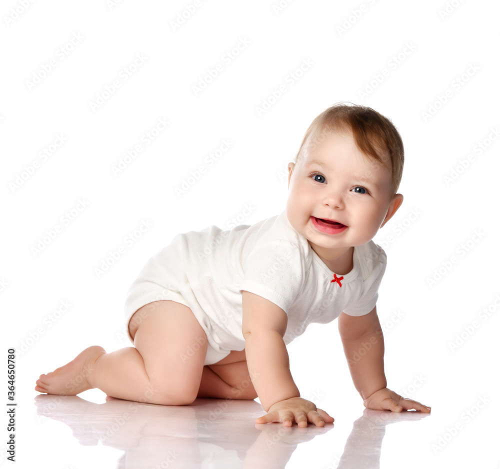 Adorable smiling little baby infant in white cotton bodysuit crawling creeping side to camera looking at us Adorable smiling little baby infant in white cotton bodysuit crawling creeping side to camera looking at us