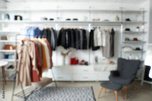 Stylish interior of modern clothes store, blurred view © Pixel-Shot
