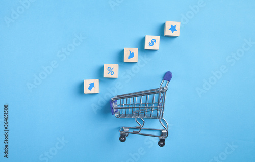 Shopping card. Business symbols on wooden cubes. Shopping