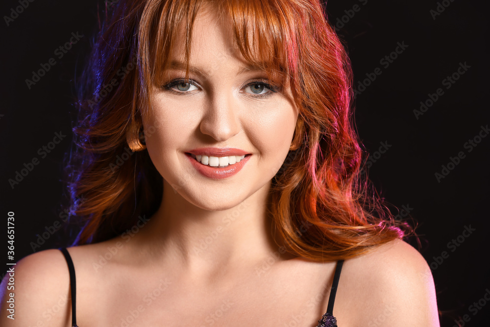 Beautiful young redhead woman on dark background Beautiful young redhead woman on dark background