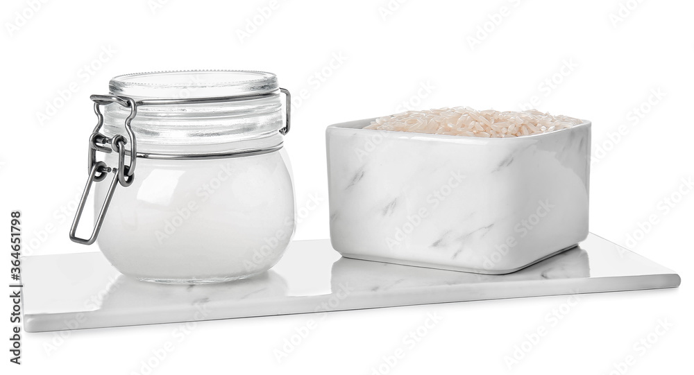 Obraz Jar of rice water on white background