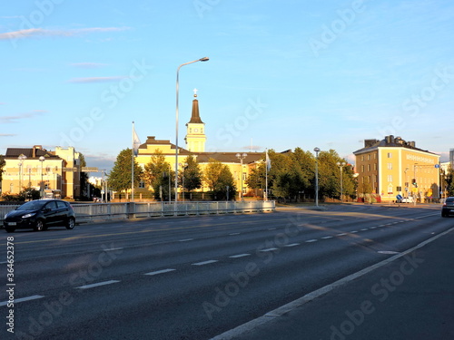 View of the road, church in summer Oulu, Finland