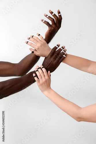 Obraz Hands of Caucasian woman and African-American man on light background. Racism concept
