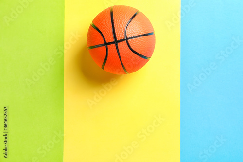 Ball for playing basketball game on color background