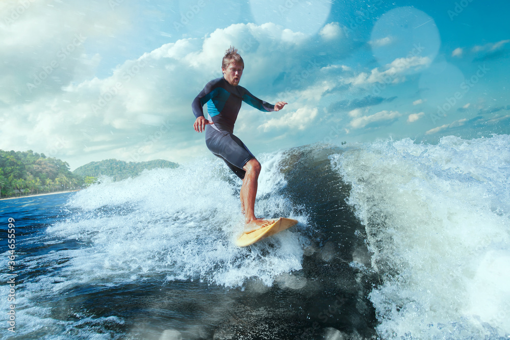 Surfer on Blue Ocean Wave Getting Barreled. 