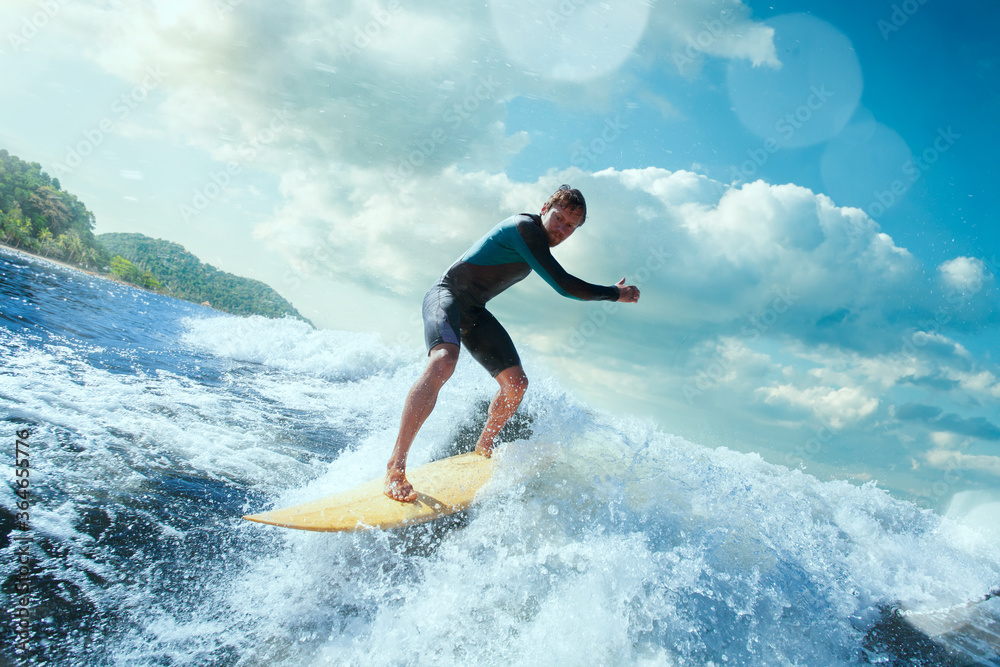 Surfer on Blue Ocean Wave Getting Barreled. 