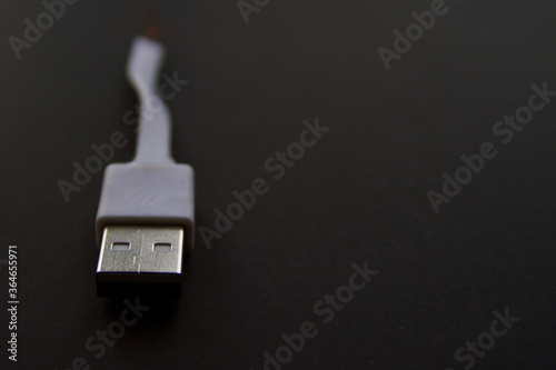 Broken smart phone charger cable isolated on black background with copy space