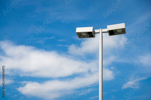 White Double street light lamp post or lantern on a blue sky background