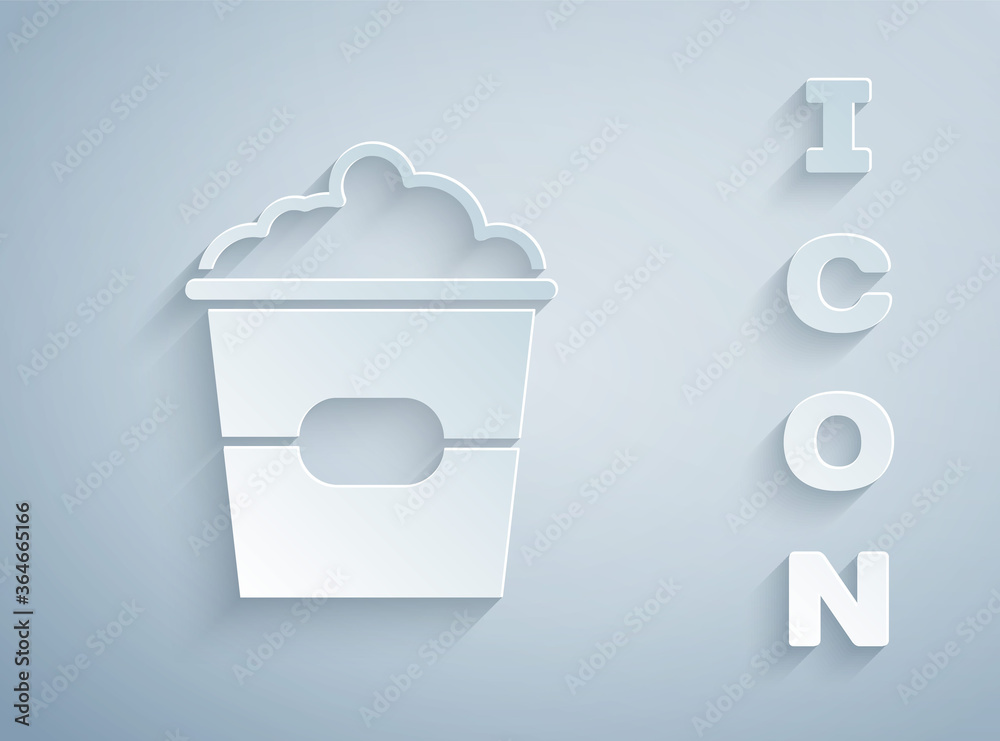 Paper cut Popcorn in cardboard box icon isolated on grey background. Popcorn bucket box. Paper art style. Vector Illustration.
