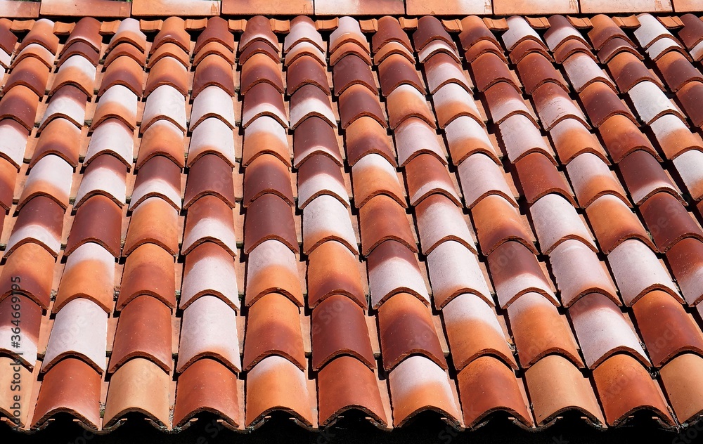 New roof terracotta tiles with different range of brown color. Background and texture New roof terracotta tiles with different range of brown color. Background and texture