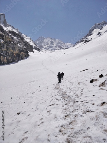 Manali, India - June 14th 2019: A group of friends/hikers climbing a narrow snowy/Glacial valley to reach the top of the Indian Himalayan Mountain Peak.  Hampta Pass trek near Manali. © Anuroop