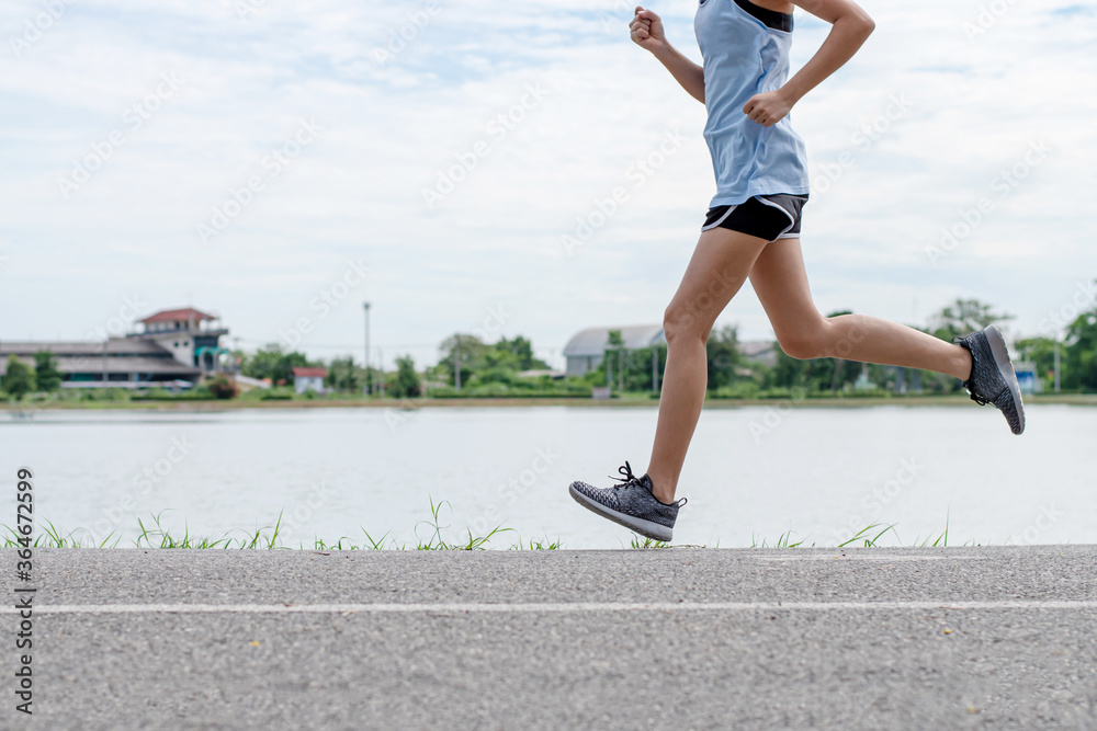 Asian women runners, She was running on the road in the morning.