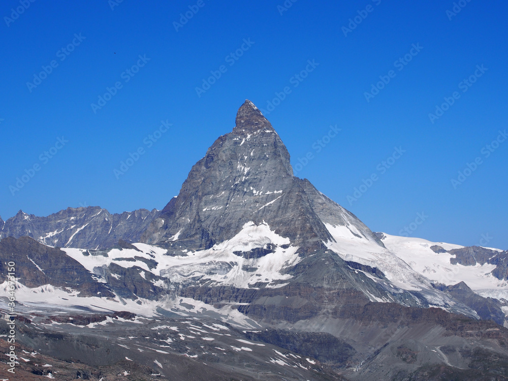 Fototapeta premium Matterhorn seen from the mountain climbed by the train in Zermatt on a sunny day.