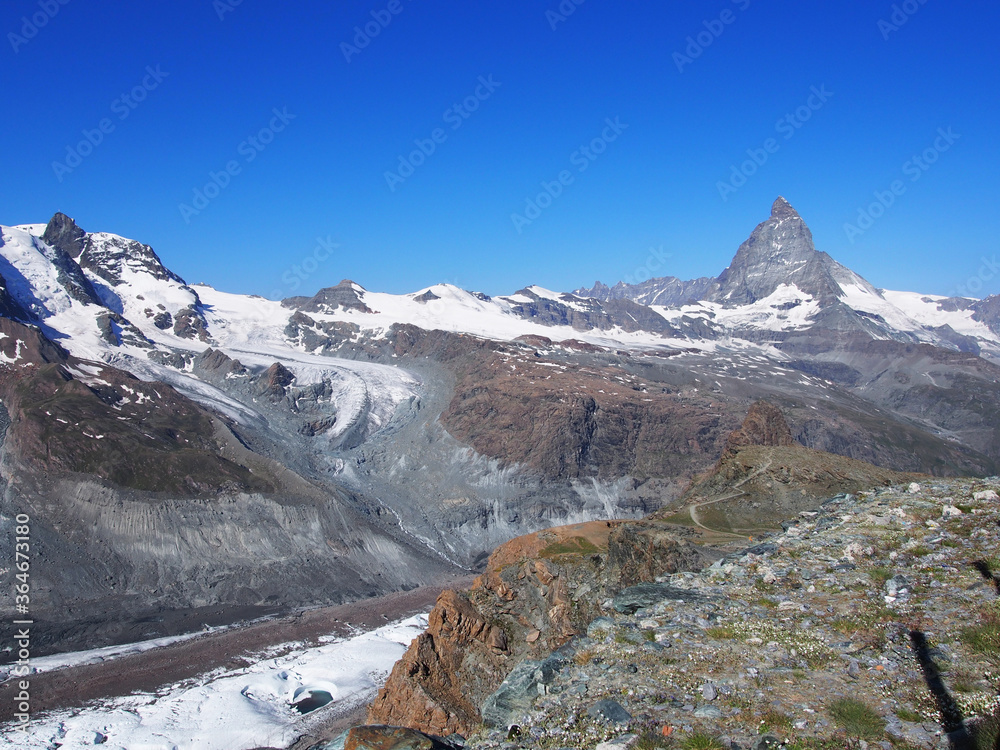 Matterhorn seen from the mountain climbed by the train in Zermatt on a sunny day.