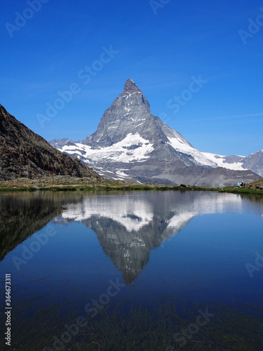Matterhorn seen from the mountain climbed by the train in Zermatt on a sunny day.