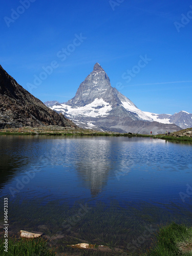 Matterhorn seen from the mountain climbed by the train in Zermatt on a sunny day.