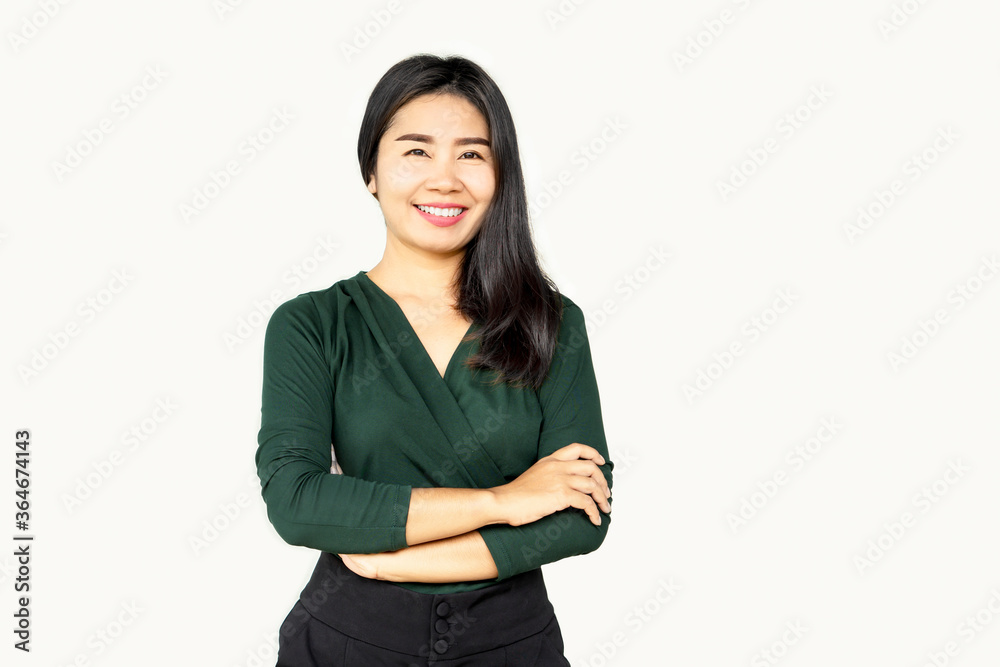 Portrait of confidence business Asian women with arms crossed standing and smile isolated over grey background Portrait of confidence business Asian women with arms crossed standing and smile isolated over grey background