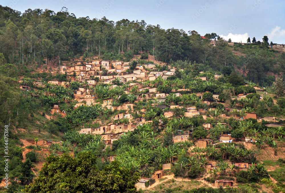 Landscape with houses against a steep slope on a deforested hill in Rwanda