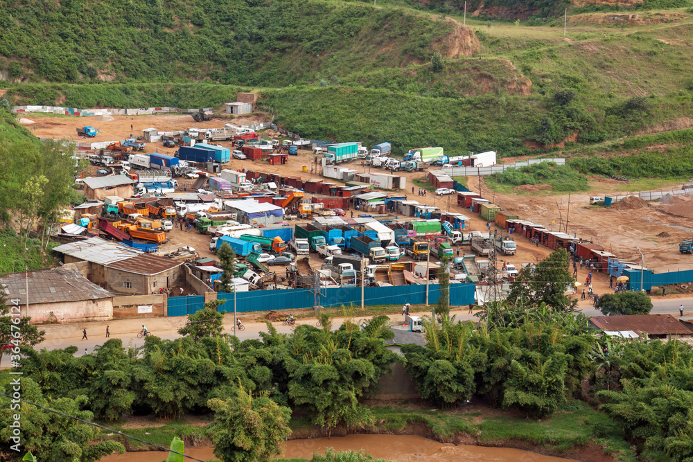 KIGALI, RWANDA: fenced truck park with second hand trucks for sale, along the western outfall road