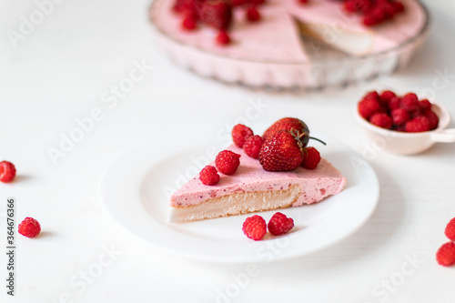 Homemade Cheesecake with Fresh raspberries berries dessert on a white plate on the table