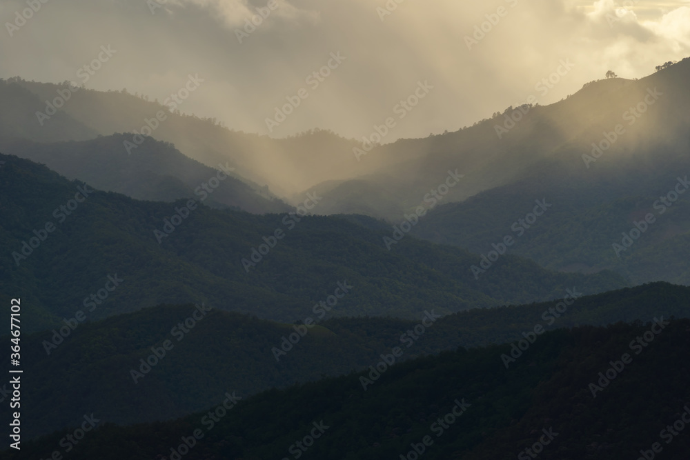 Landscape of Distant mountain range and layer in morning sun ray and white fog at the valleys, Chiang Mai in Thailand