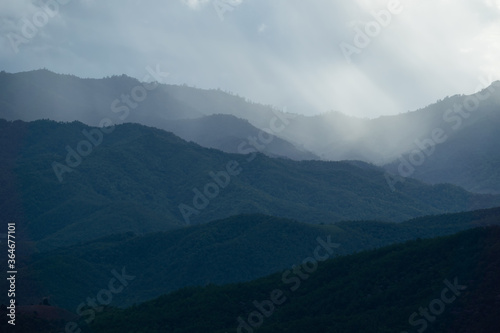 Landscape of Distant mountain range and layer in morning sun ray and white fog at the valleys, Chiang Mai in Thailand