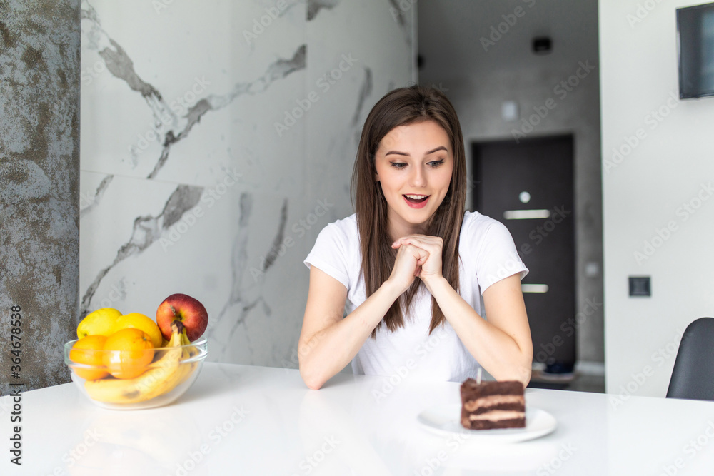 Diet. Dieting concept. Healthy Food. Beautiful Young Woman choosing between Fruits and Sweets Diet. Dieting concept. Healthy Food. Beautiful Young Woman choosing between Fruits and Sweets