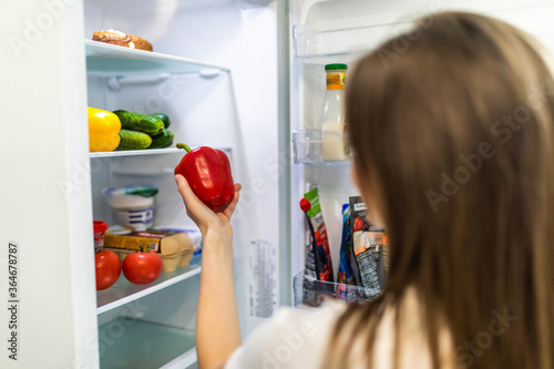 Healthy eating concept. Diet. Beautiful young woman near the refrigerator with healthy food. Fruits and vegetables in a Fridge