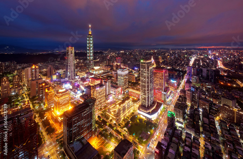 Aerial skyline of Downtown Taipei at night  the vibrant capital city of Taiwan  with towers standing out among modern skyscrapers in Xinyi Commercial District and city lights dazzling in the dark