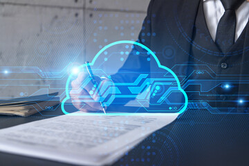 Businessman in suit signs contract. Double exposure with cloud icon hologram. Partnership in it business and data storage concept.