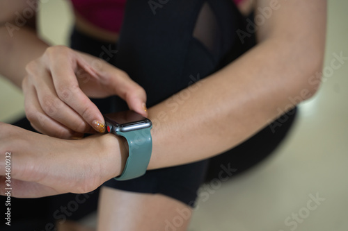 Close up of Fitness female checking progress on smart watch. Looking at smart watch heart rate monitor..