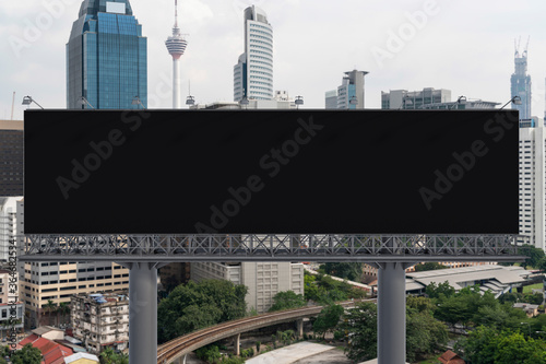 Photography Blank black road billboard with Kuala Lumpur cityscape background at day time