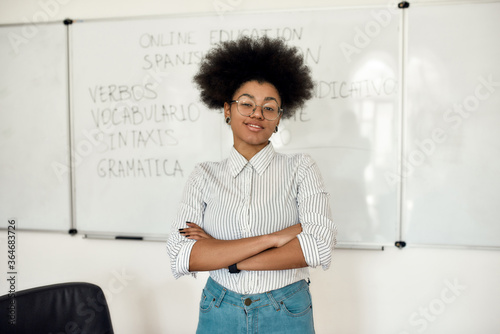Learn Spanish Online. Portrait of young happy afro american woman, female teacher looking at camera and smiling while teaching Spanish language online from home