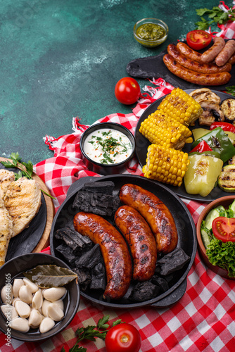 Grilled sausages, meat, and vegetables. © Yulia Furman
