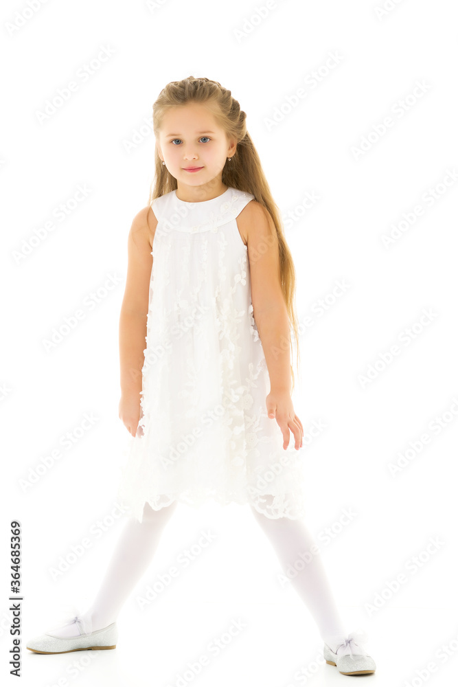 Naklejka premium Little girl in an elegant dress.The concept of a happy childhood