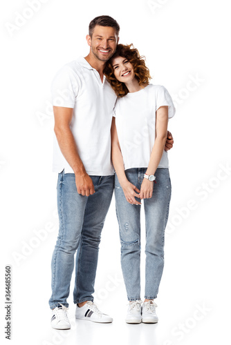 happy man smiling while hugging cheerful woman on white