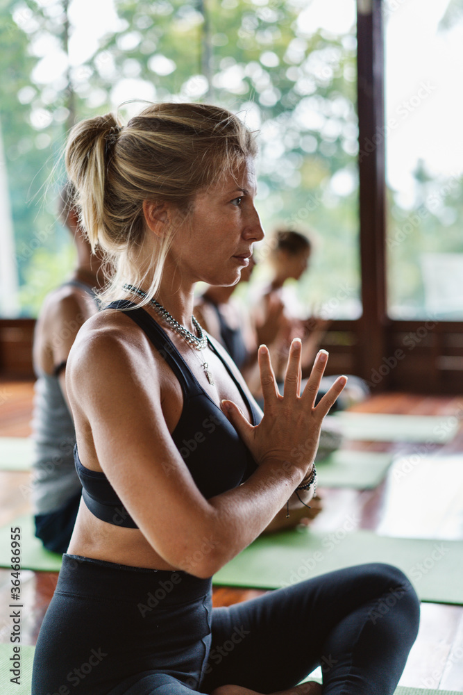 People meditating together in a yoga class.