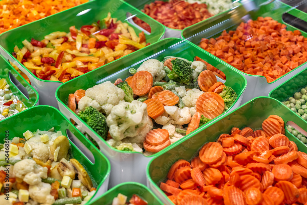 A variety of frozen foods lie in white cups.