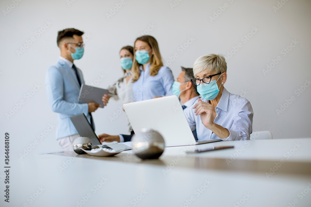 Group of business people have a meeting and working in office and wear masks as protection from corona virus Group of business people have a meeting and working in office and wear masks as protection from corona virus