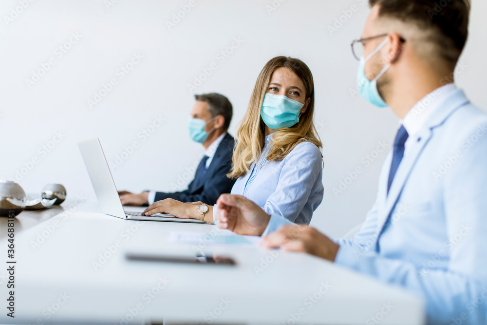 Group of business people have a meeting and working in office and wear masks as protection from corona virus - obrazy, fototapety, plakaty 