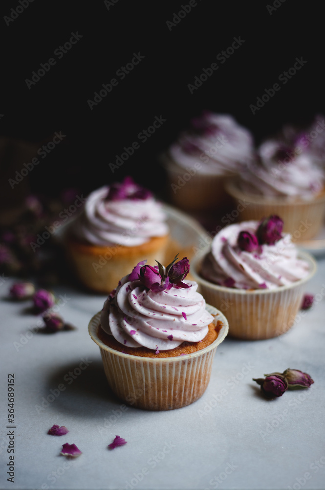 Cupcakes with raspberry cream and roses
