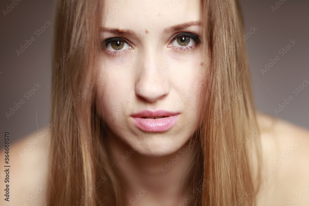 Fototapeta premium Emotional girl portrait on the brown background