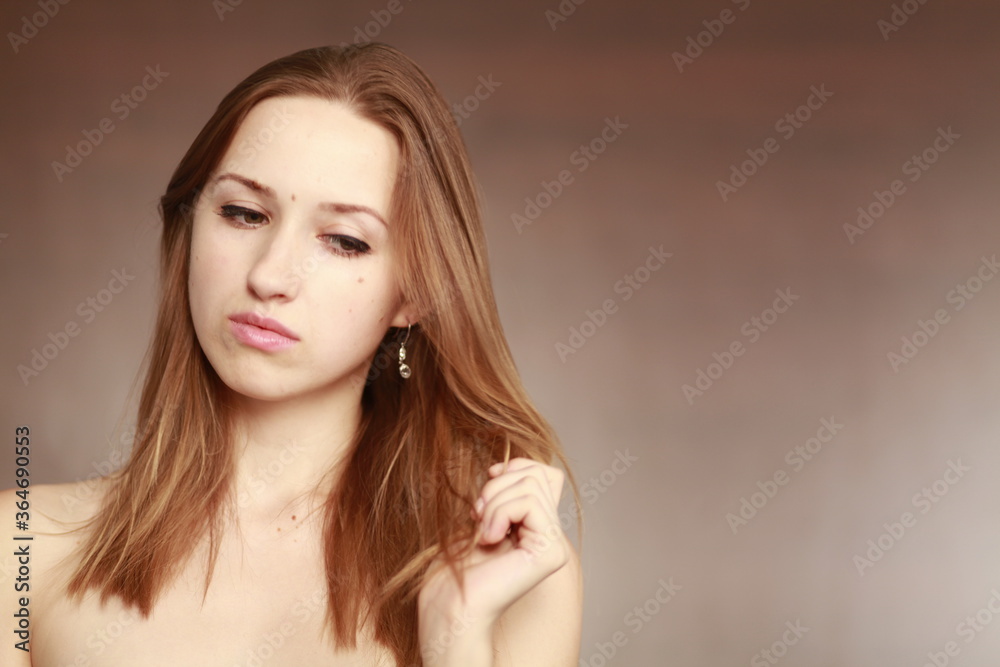 Fototapeta premium Emotional girl portrait on the brown background